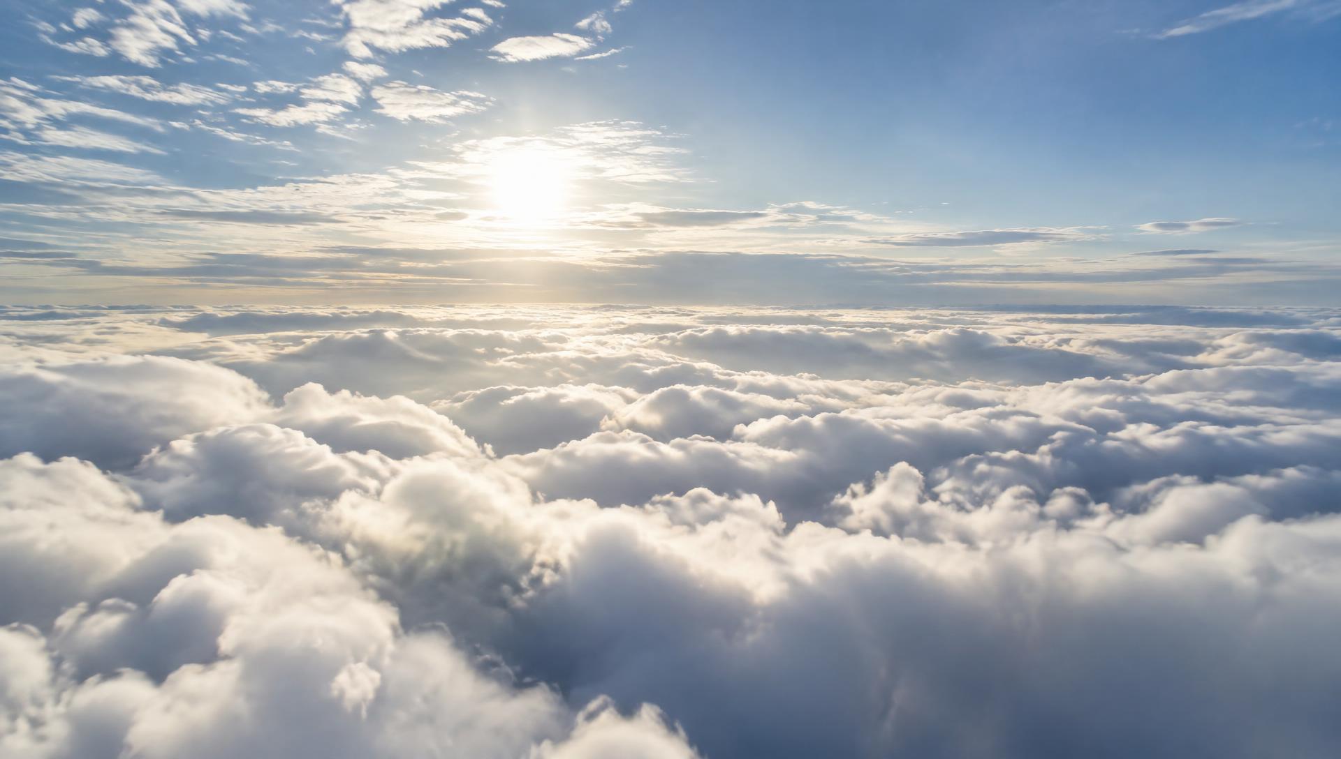 Aerial view above a sea of white clouds